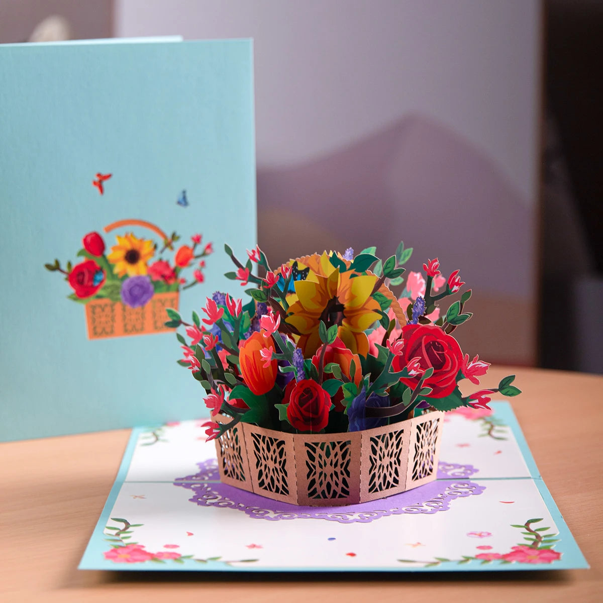 a card with a basket of flowers on a table