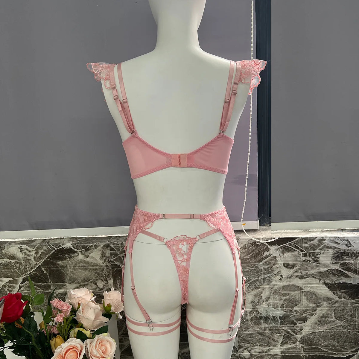 Pink lace bra and garter set for women, featuring ruffle straps, adjustable fit, and elegant embroidery. Affordable lingerie in NZ.