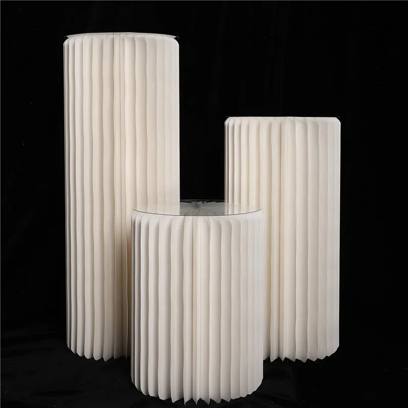 three white vases sitting next to each other on a black background