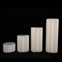 a group of three white vases sitting next to each other