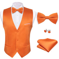 a man wearing an orange vest and bow tie