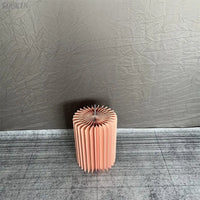 a pink vase sitting on top of a rug