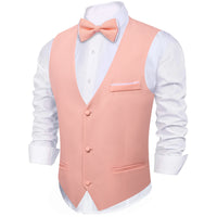 a man wearing a pink vest and bow tie