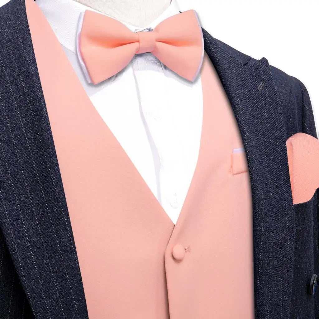 a man in a suit with a pink bow tie