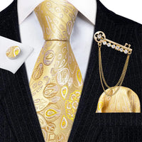 a man wearing a suit and tie with a gold tie clip