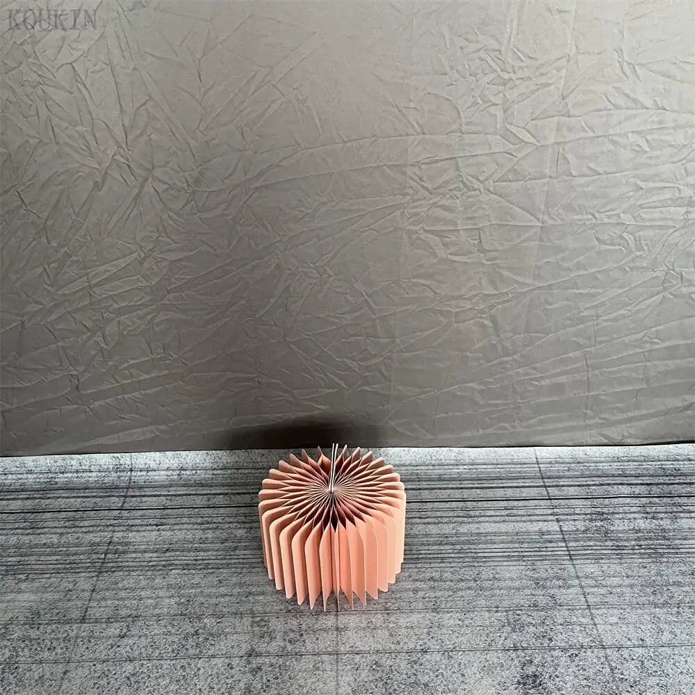 a pink sculpture sitting on top of a floor next to a wall