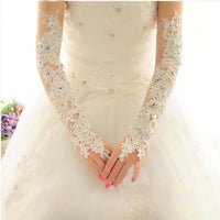 a woman in a white wedding dress holding her hands together