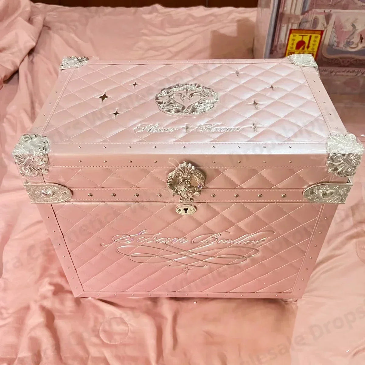 a pink box sitting on top of a bed