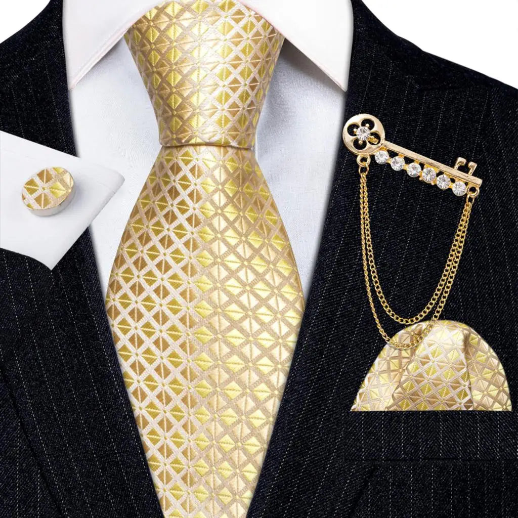 a man wearing a suit and tie with a gold tie pin