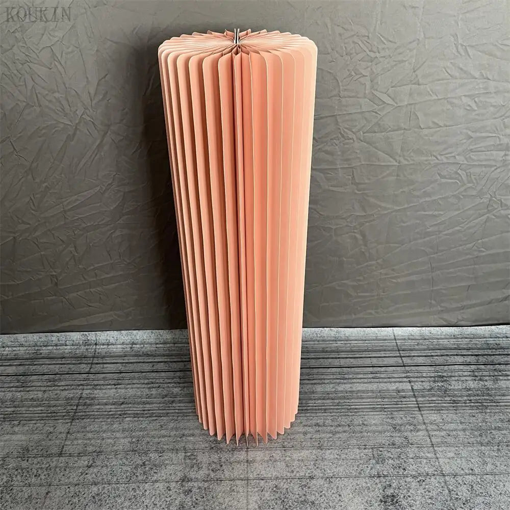 a tall pink vase sitting on top of a floor
