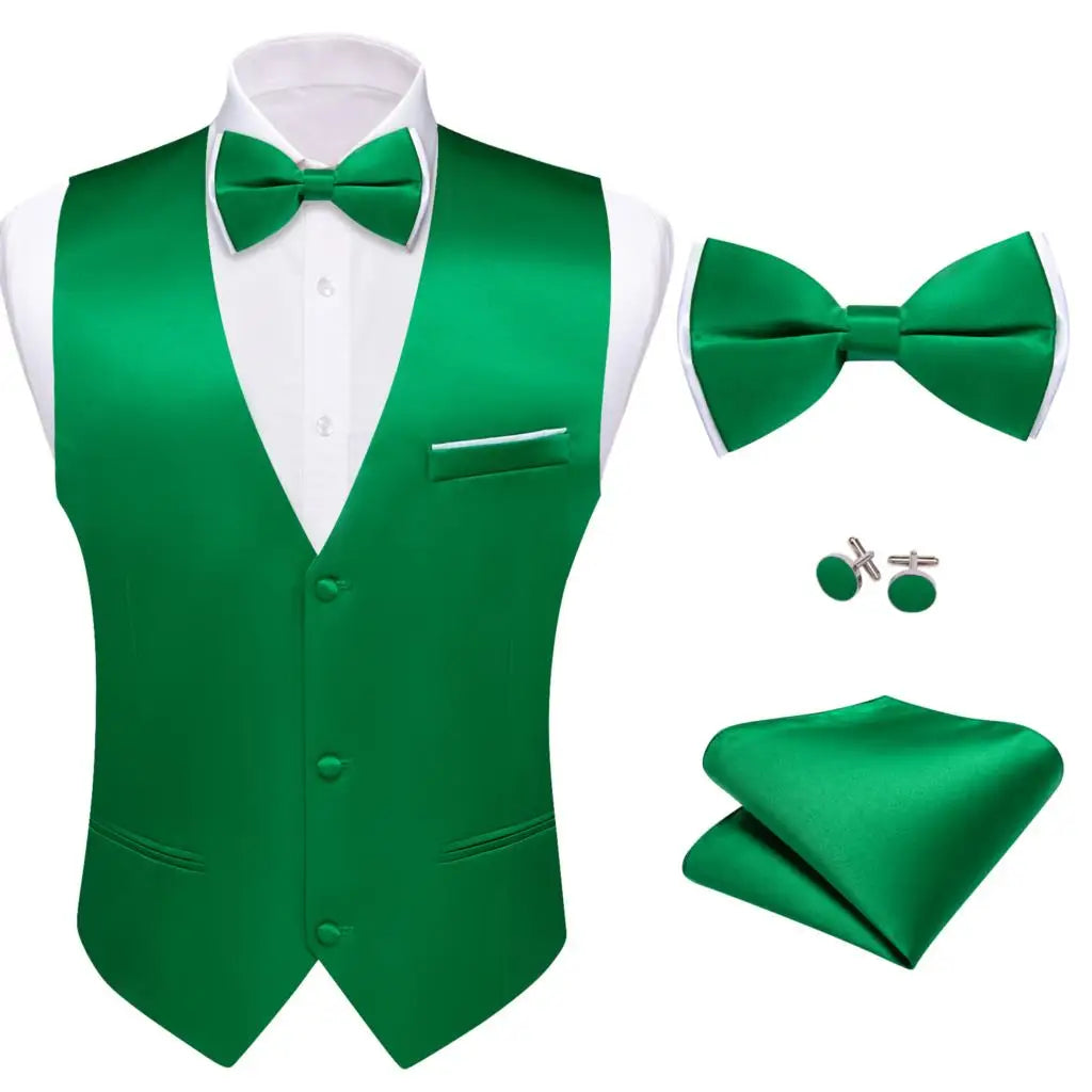 a green suit with a bow tie and cufflinks