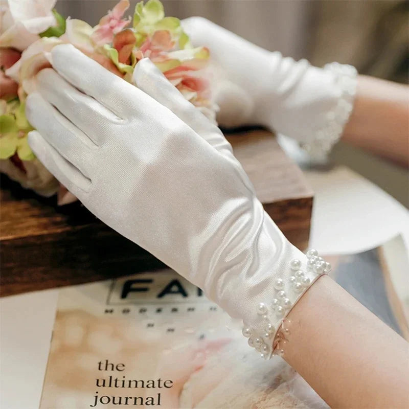 a pair of white gloves sitting on top of a table