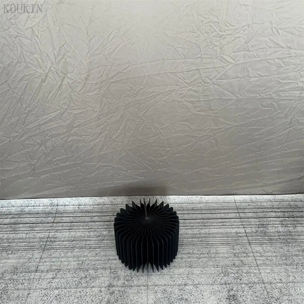 a black sculpture sitting on top of a white floor