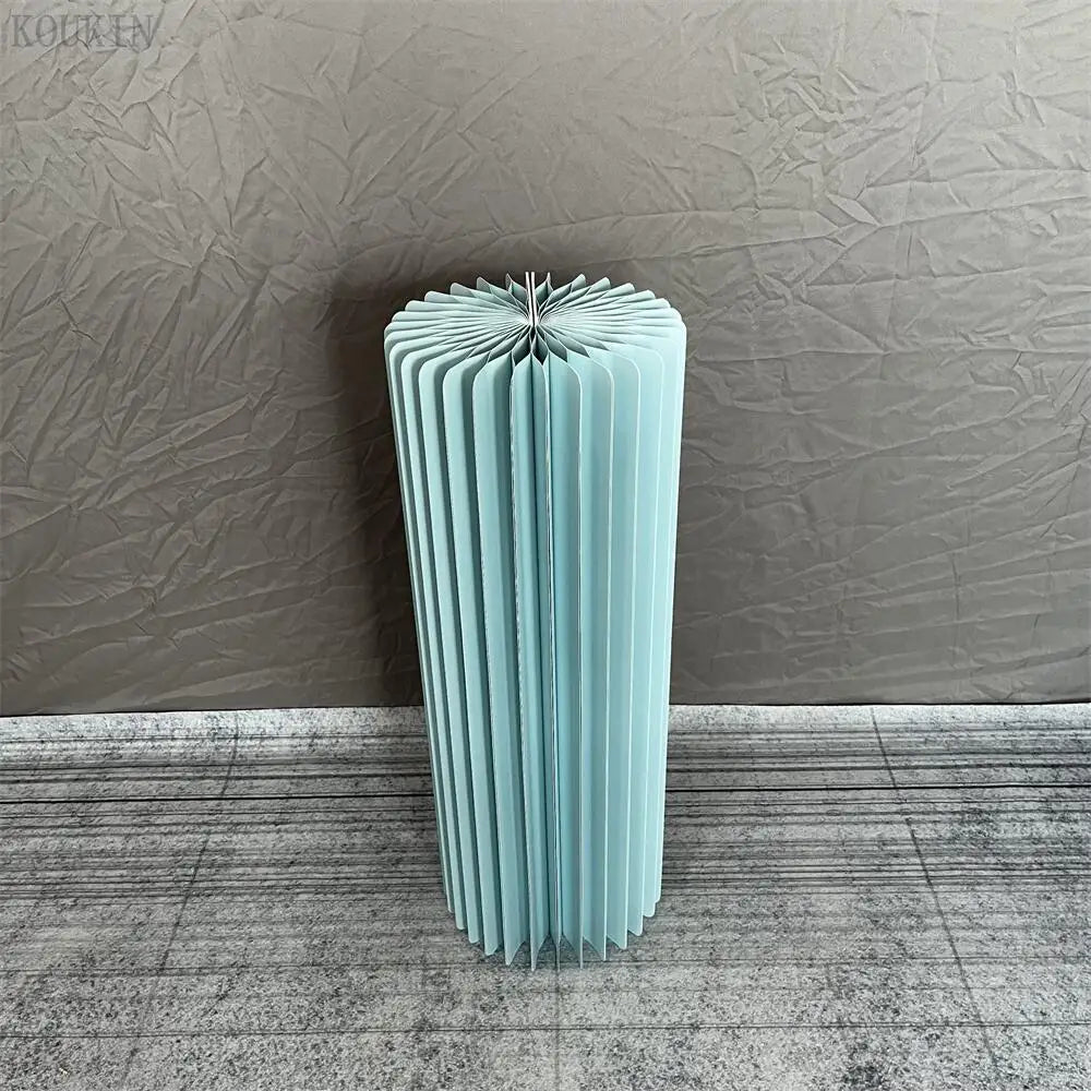 a tall blue vase sitting on top of a floor