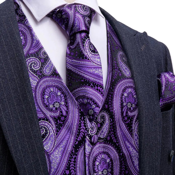 a man wearing a purple paisley tie and a suit