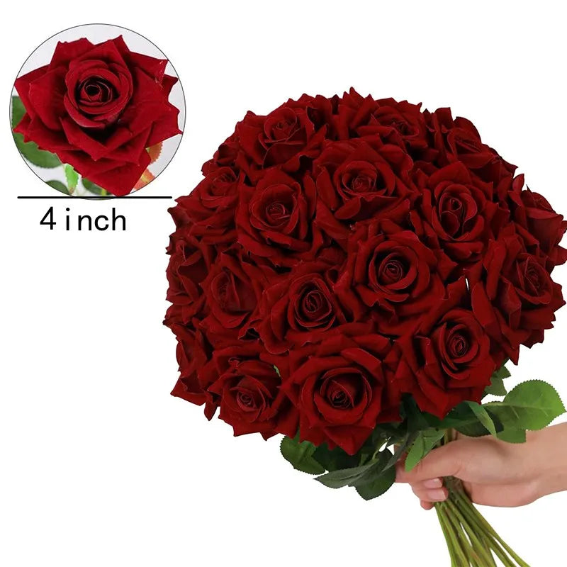 a hand holding a bouquet of red roses