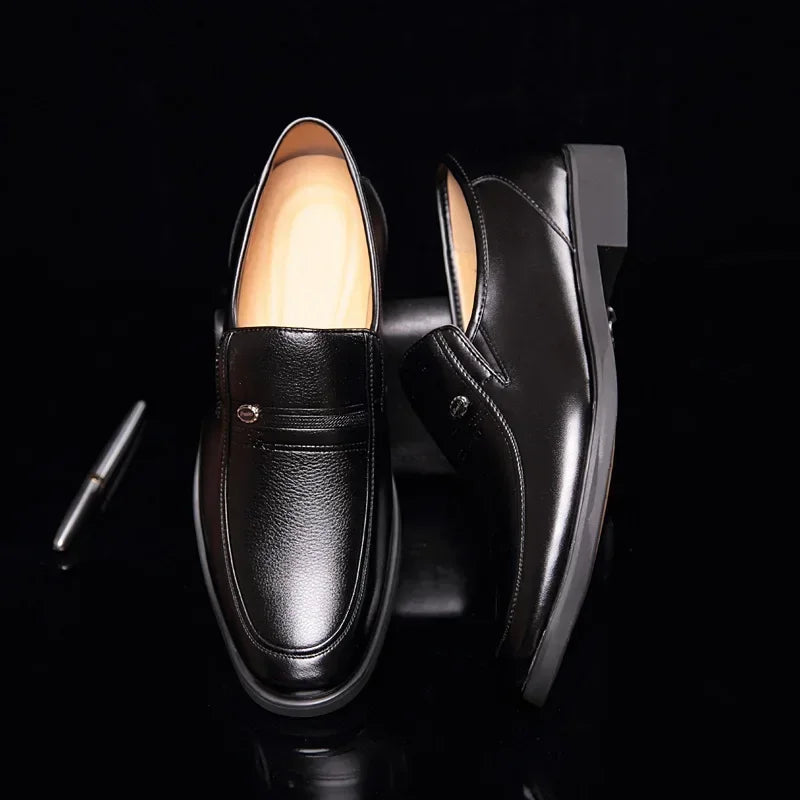 a pair of black shoes sitting on top of a black table