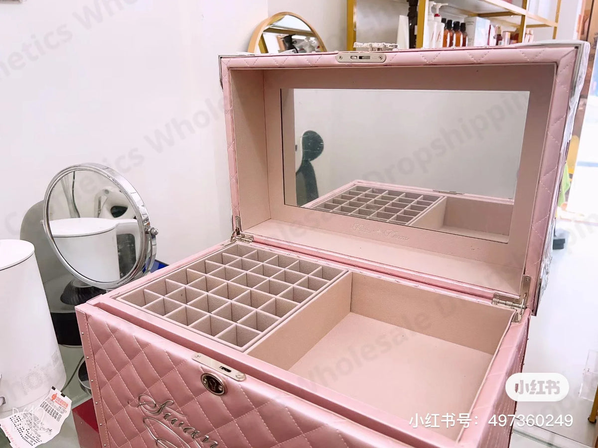 a pink jewelry box sitting on top of a table
