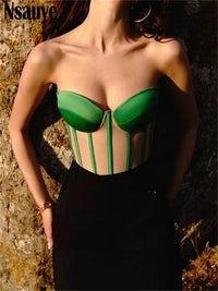 a woman wearing a green and black corset