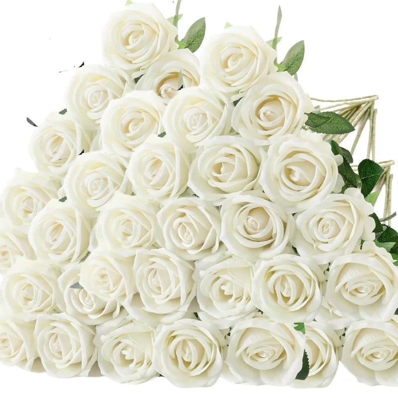 a bouquet of white roses with green leaves