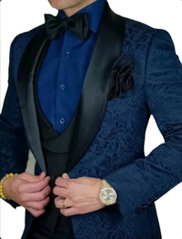 Men's blue jacquard paisley tuxedo with bow tie and waistcoat, showcasing modern elegance and style.
