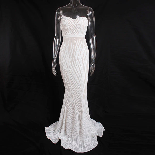 a white dress on a mannequin on a black background