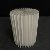 a white vase sitting on top of a black floor