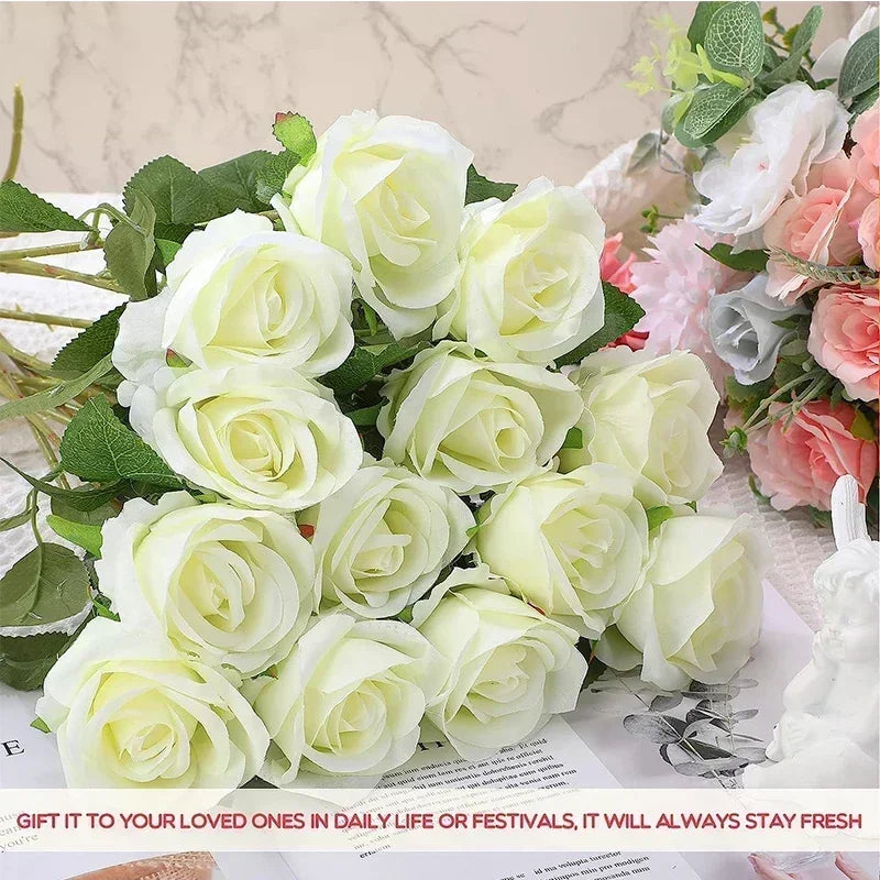 a bouquet of white roses sitting on top of a table