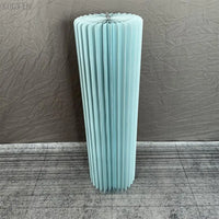 a tall blue vase sitting on top of a tile floor