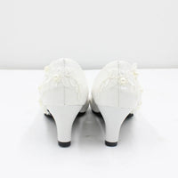 a pair of white high heels with lace