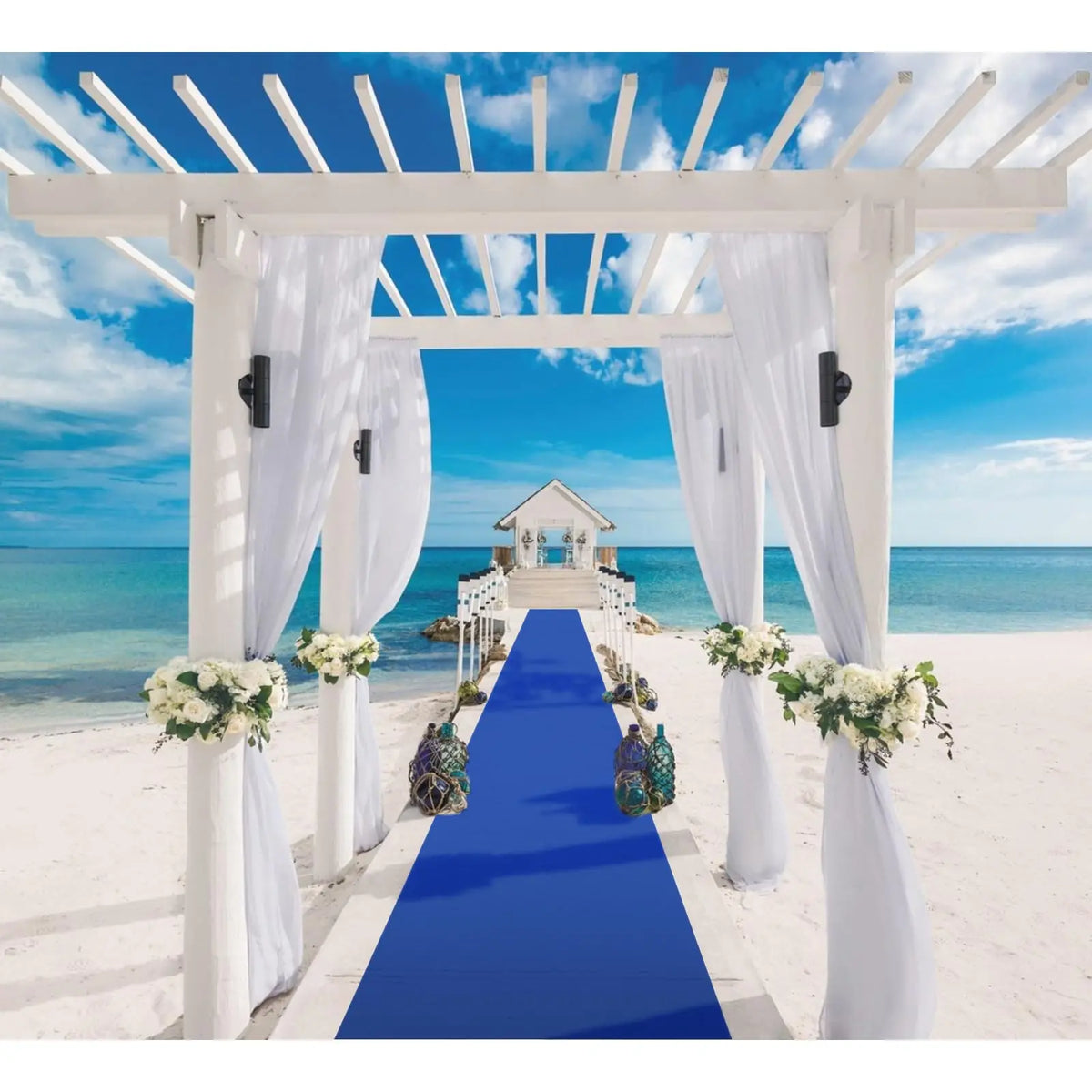 a blue and white wedding aisle on the beach
