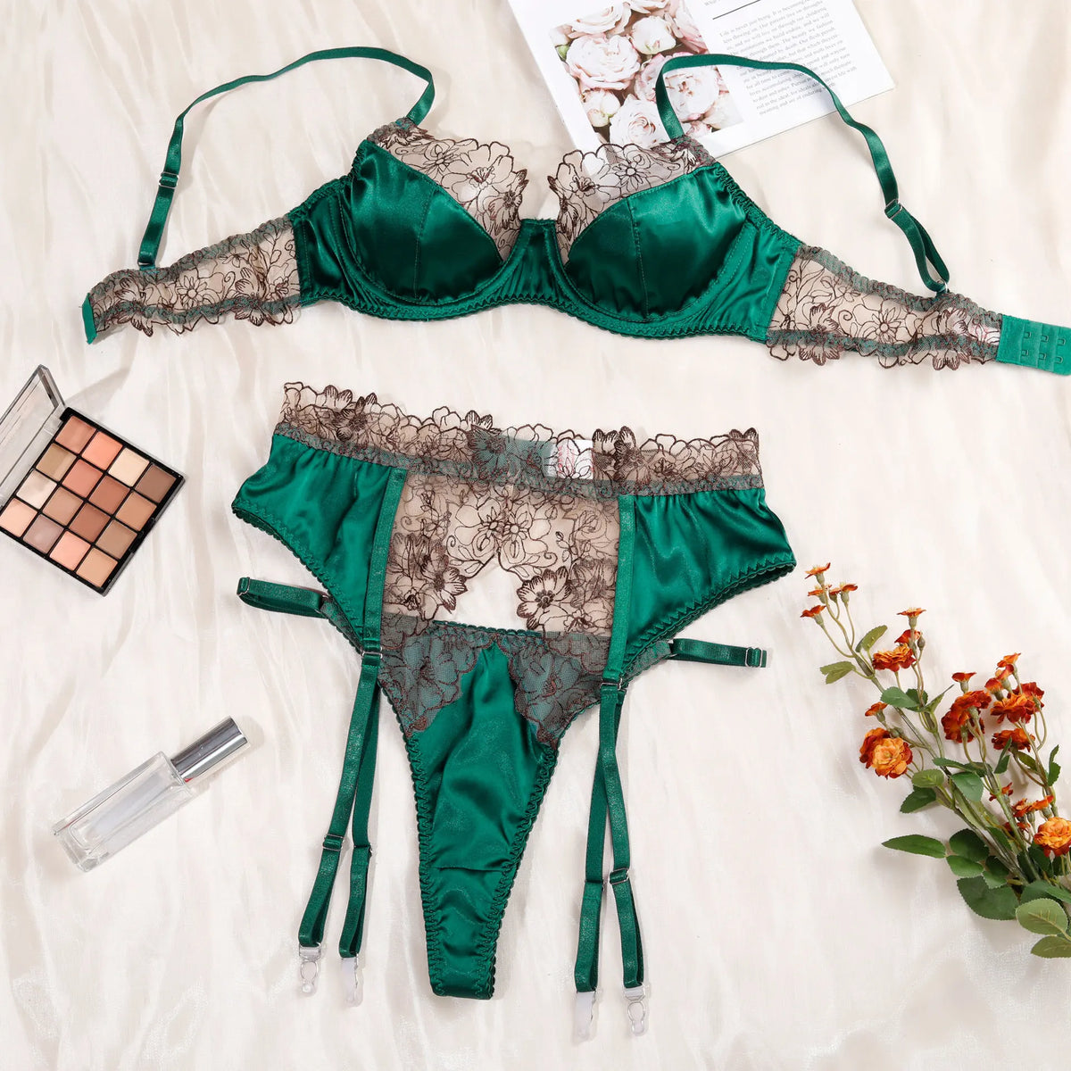 Luxury satin lace lingerie set in emerald green, featuring a bra and thong with floral detailing, perfect for special occasions.