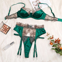 Luxury satin lace lingerie set in emerald green, featuring a bra and thong with floral detailing, perfect for special occasions.