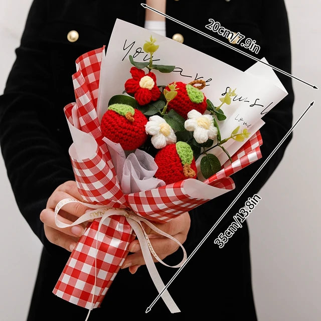 a person holding a bouquet of strawberries and flowers