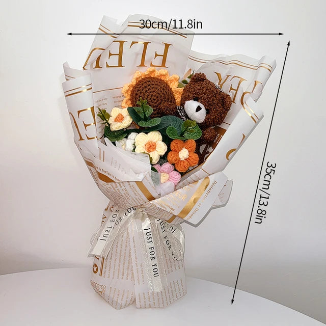 a teddy bear sitting on top of a bouquet of flowers