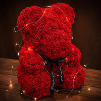 a teddy bear made out of red roses