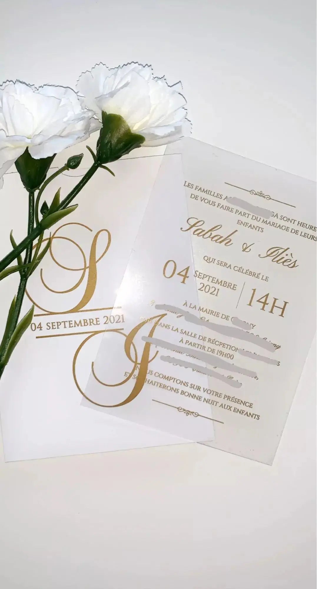 a wedding card with a flower on top of it
