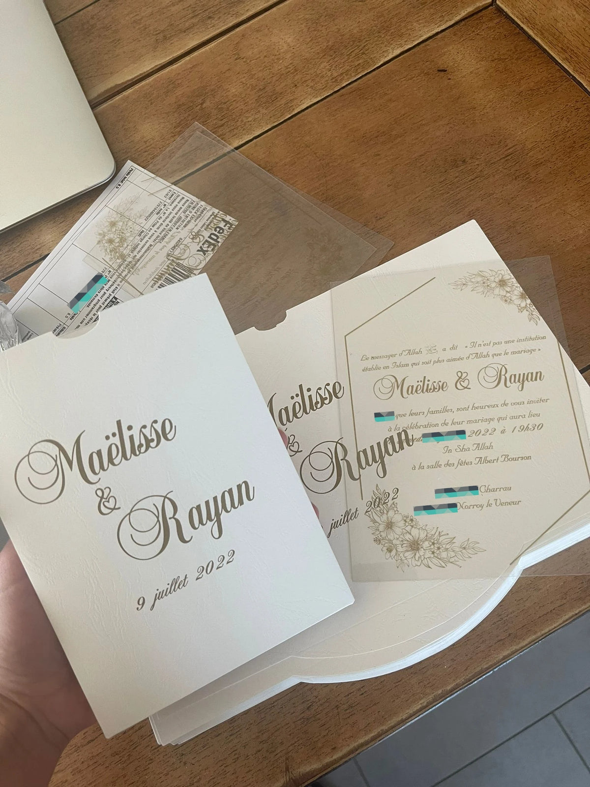 a person holding a wedding card in their hand