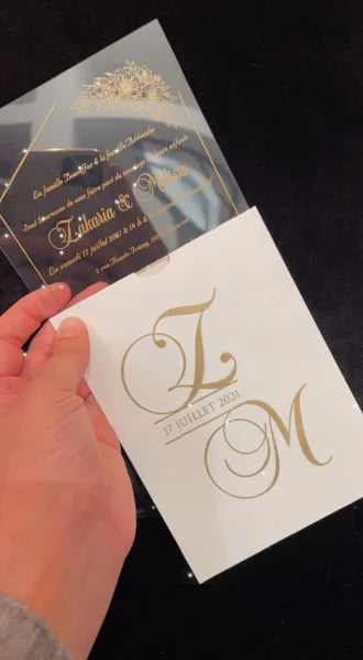 a person holding up a wedding card