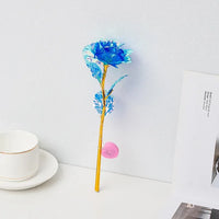 a blue flower sitting on top of a white table