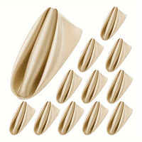 a set of gold nail tips with a white background