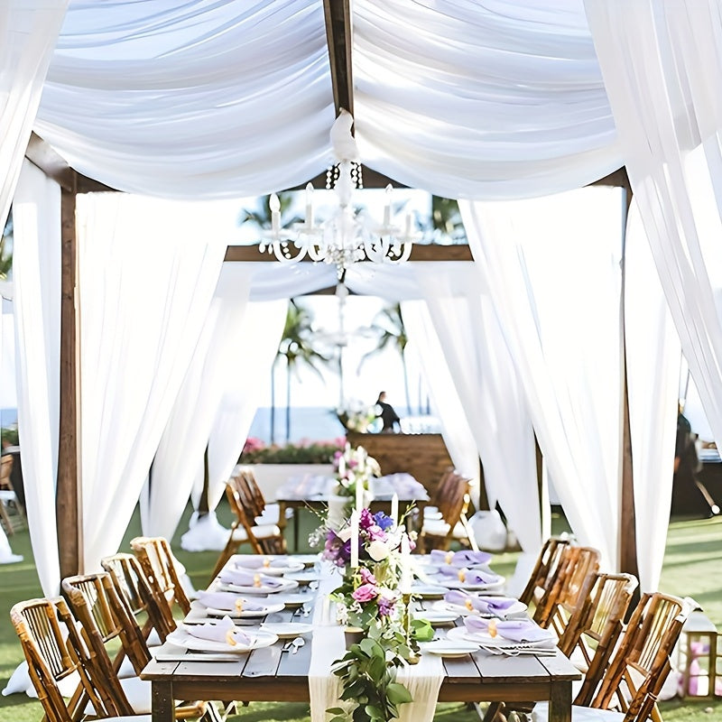 a table set up for a formal dinner under a canopy