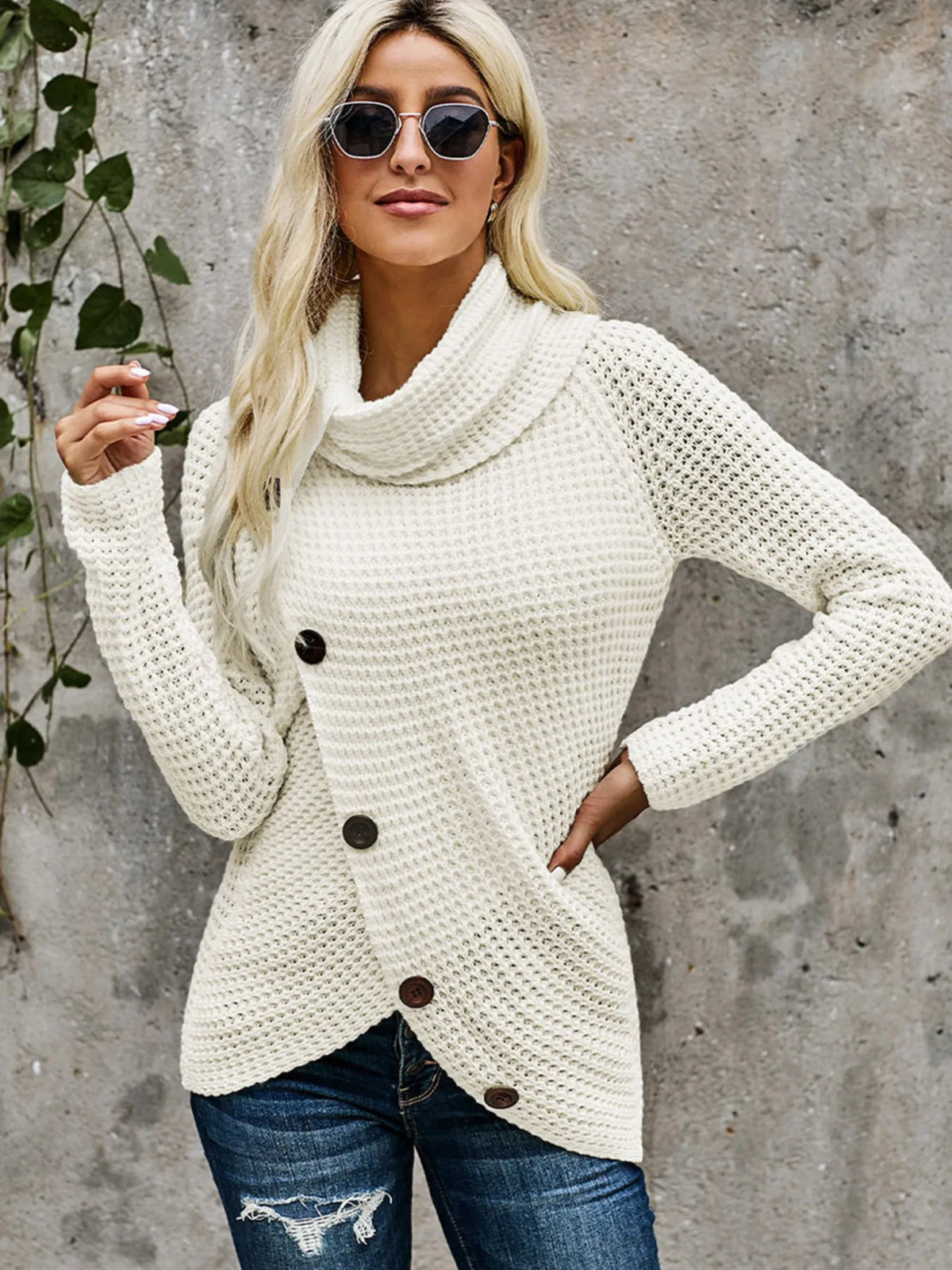 Model wearing a cream full size texture turtleneck long sleeve sweater with decorative buttons and sunglasses.
