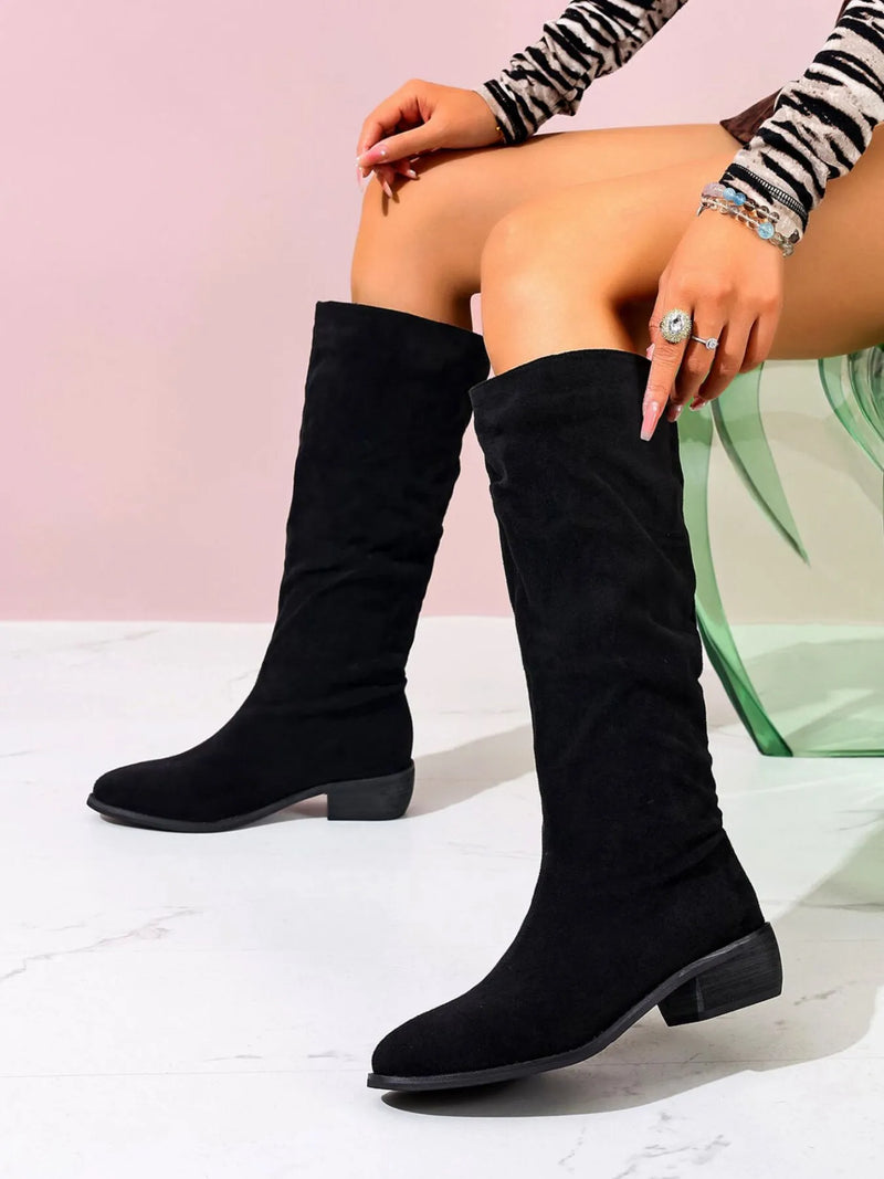 Stylish black point toe block heel boots made of suede, perfect for trendy outfits and true to size.