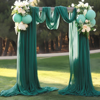 a couple of green drapes sitting on top of a lush green field