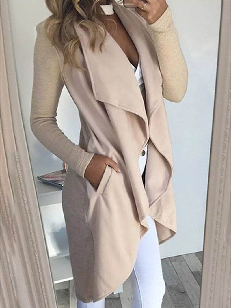 Model wearing a full-size lapel collar long sleeve coat in beige with pockets, styled over a casual outfit.