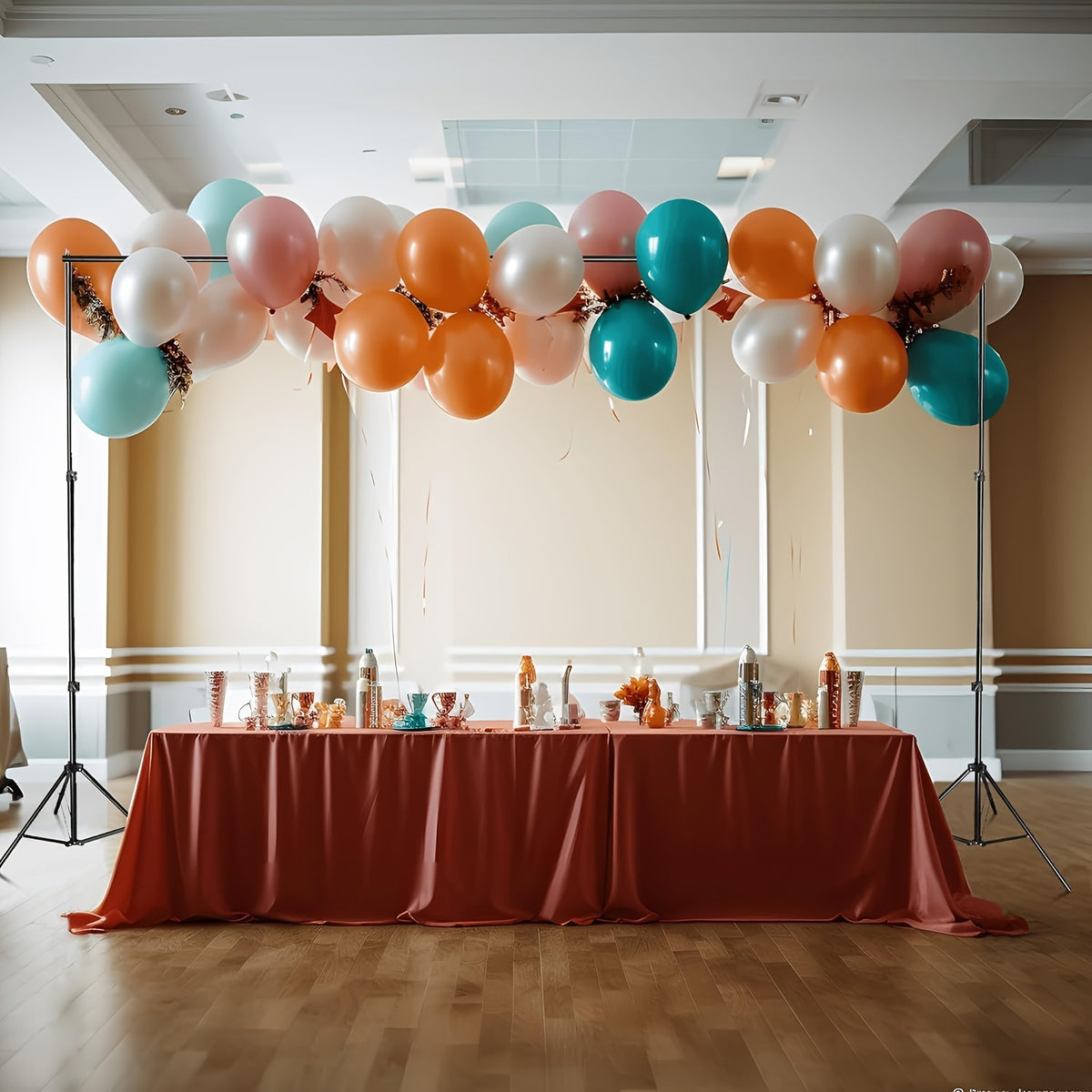 a table with a red table cloth and a bunch of balloons