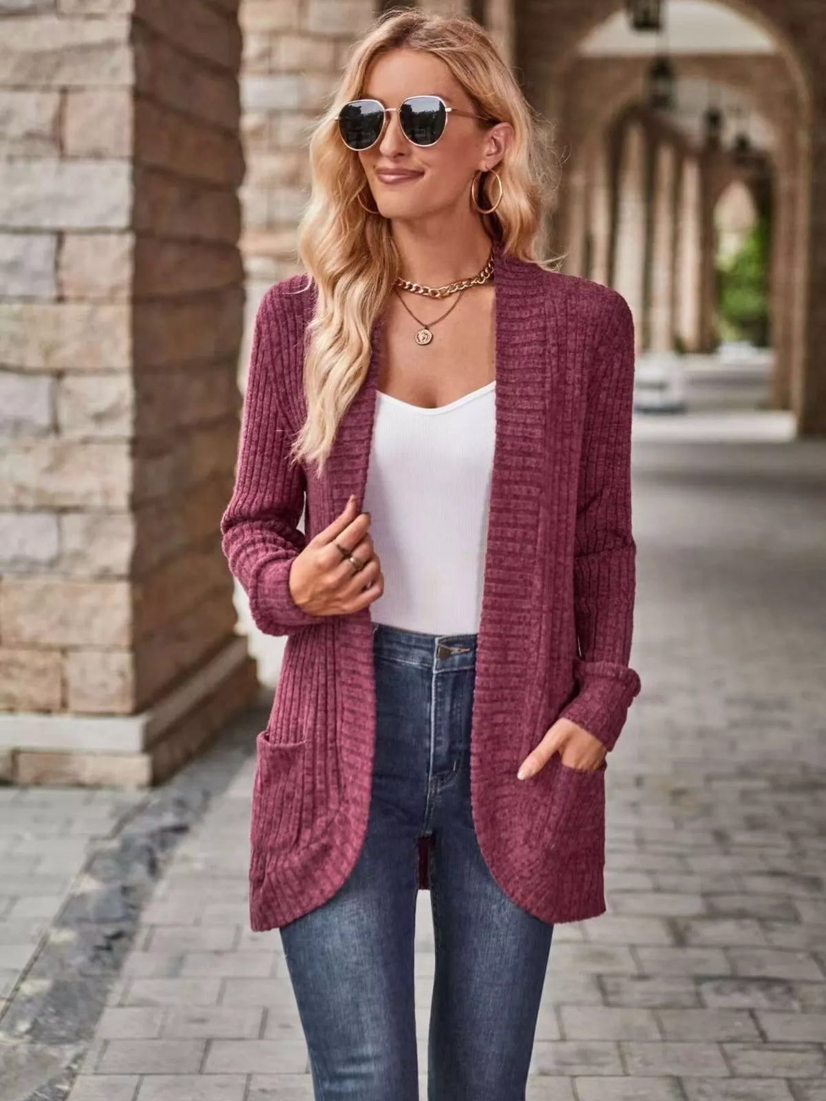 Open front ribbed knit cardigan in maroon worn with a white top and jeans, featuring pockets and a stylish look.