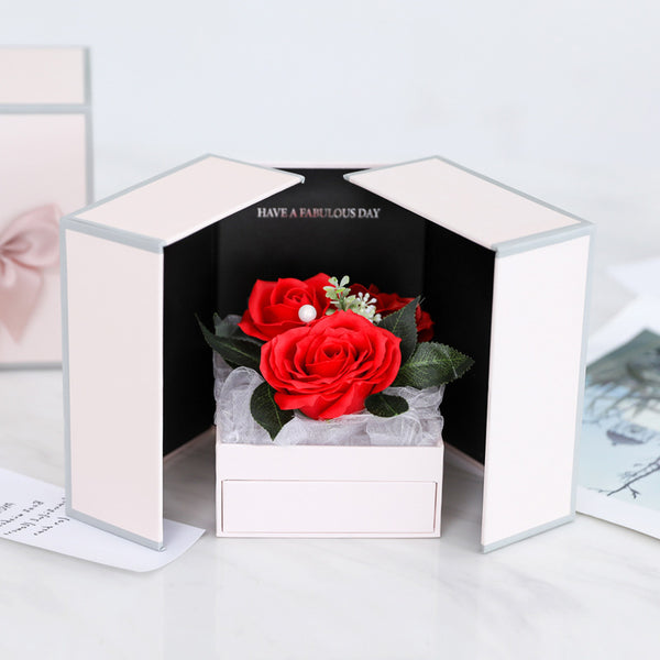 a white box with a red rose in it