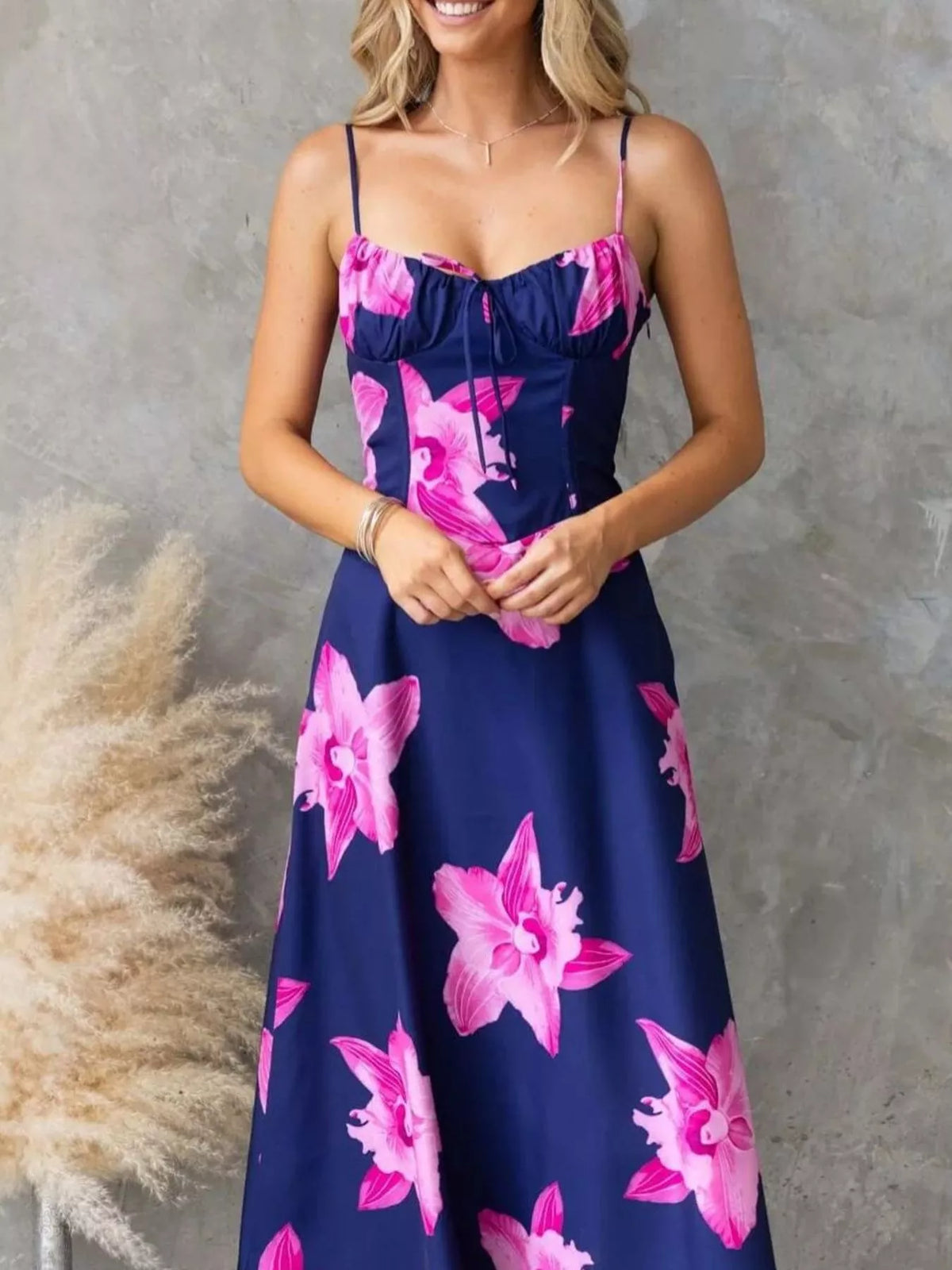 Model wearing a Floral Print Midi Cami Dress featuring pink floral designs on a navy background.